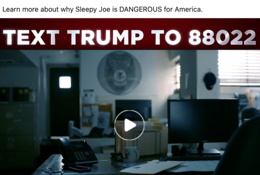 Paused video from a Trump ad. The scene shows a dark police station office with the following statement" Learn more about why Sleepy Joe is DANGEROUS for America. TEXT TRUMP TO 88022."